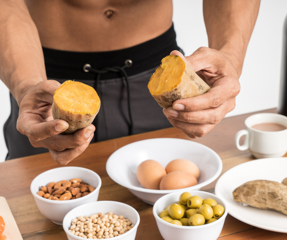 A muscular man holding a bowl of fresh salad, demonstrating natural muscle building through healthy eating.